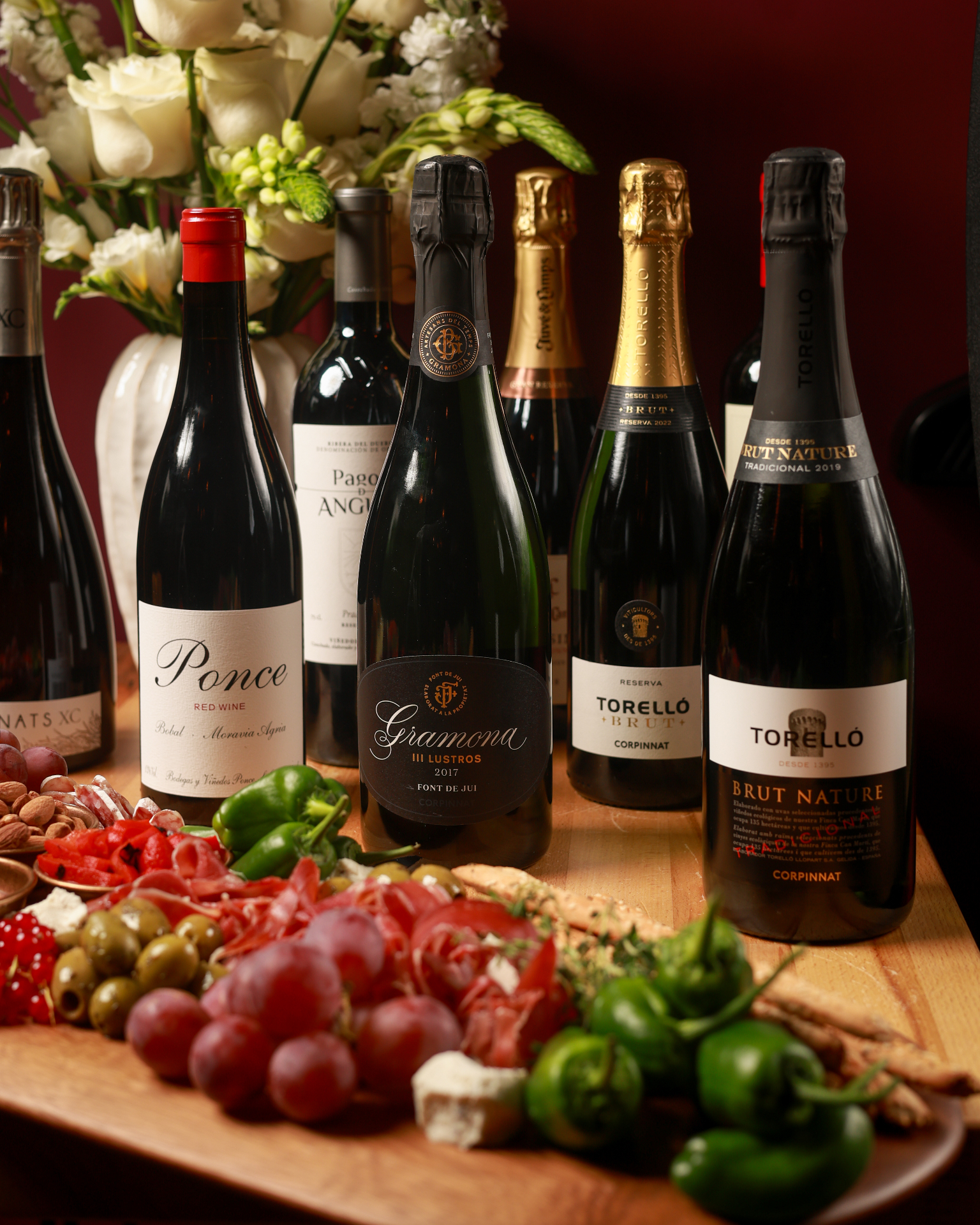 Sticlă de Cava Torelló Brut alături de platou cu mezeluri și brânzeturi